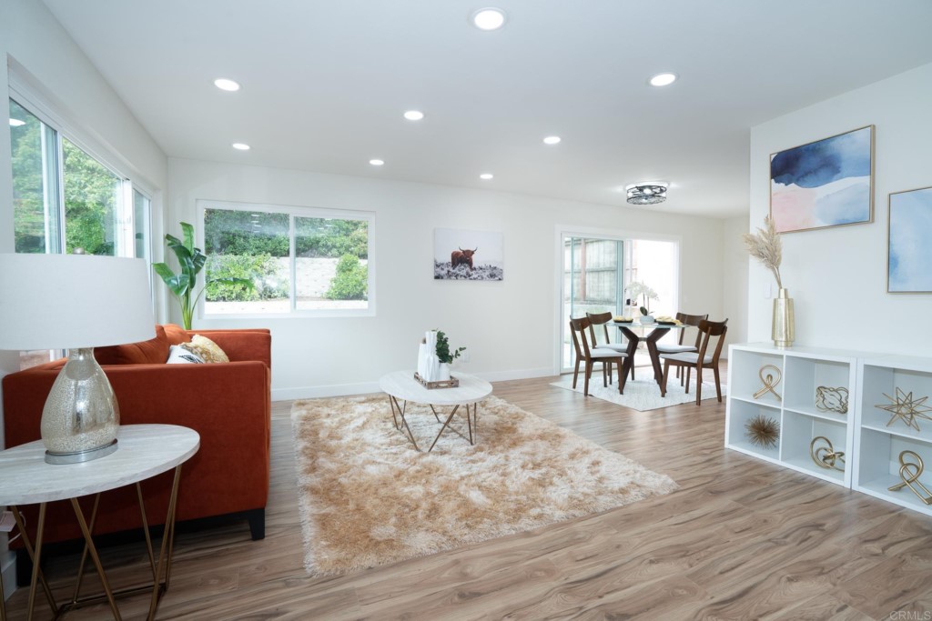 4080 Lake Boulevard Oceanside, CA 92056 - Photo 3 of 28 a living room with furniture a wooden floor and a large window