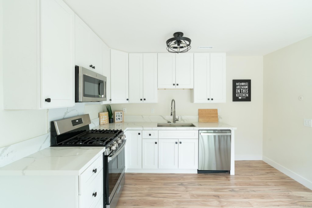 4080 Lake Boulevard Oceanside, CA 92056 - Photo 8 of 28 a kitchen that has a sink a stove and cabinets