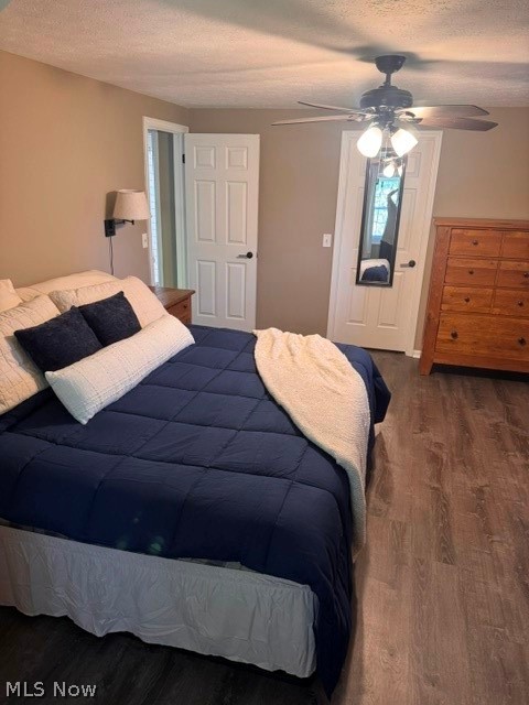 2760 Haines Road Madison, OH 44057 - Photo 25 of 33 Interior room featuring wood-finish flooring, two panel-style doors with black hardware, and a ceiling fan with integrated lighting