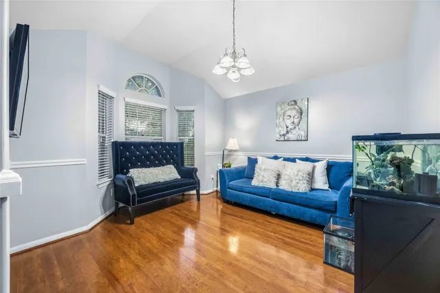a living room with a couch and a chandelier