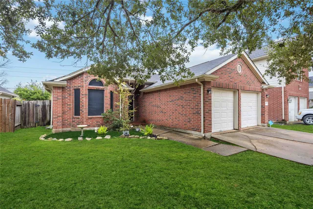 a front view of a house with a garden and yard