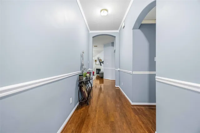 a view of a hallway with wooden floor