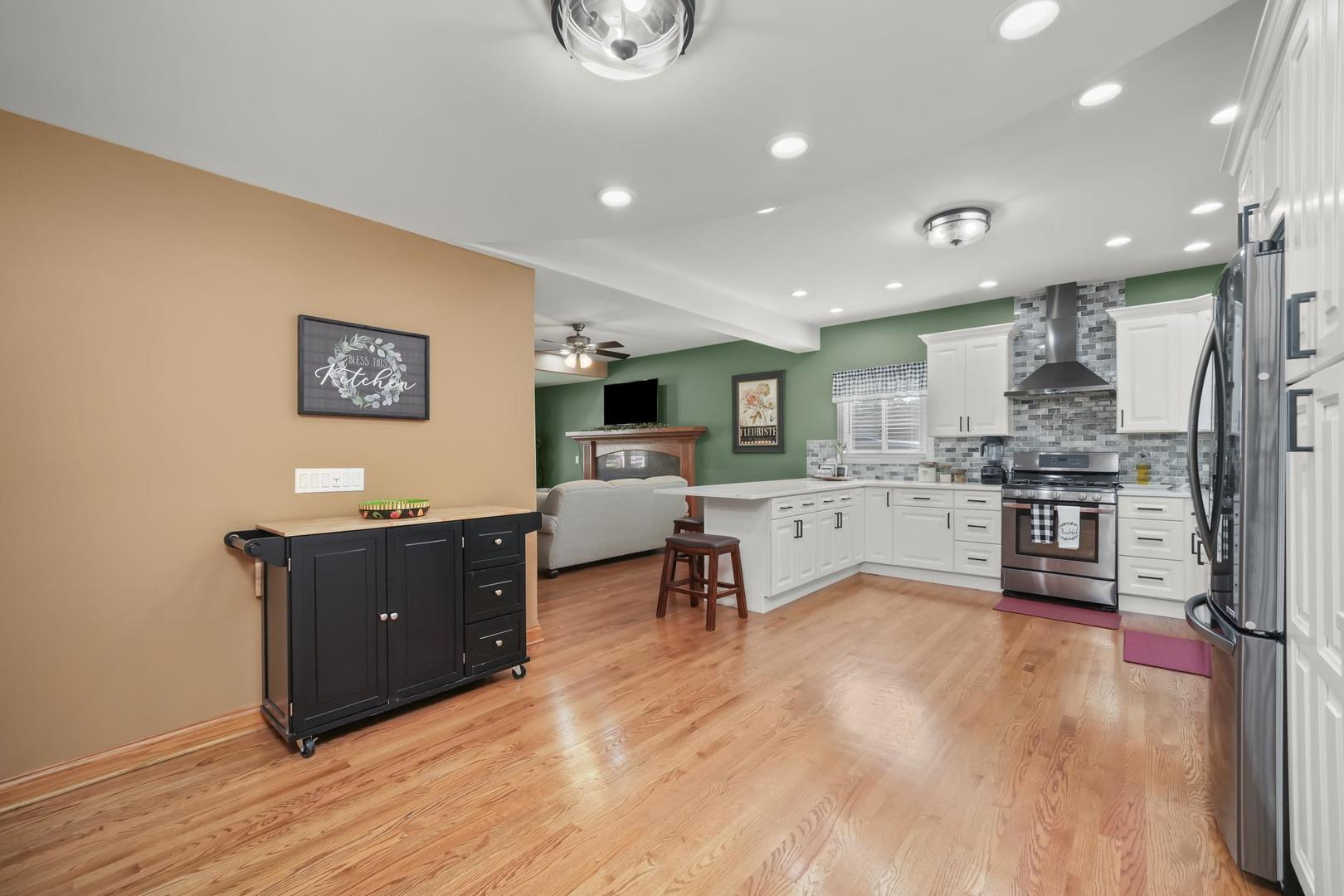 5907 West 109th Street Chicago Ridge, IL 60415 - Photo 12 of 45 a living room with stainless steel appliances granite countertop furniture wooden floor and a view of kitchen
