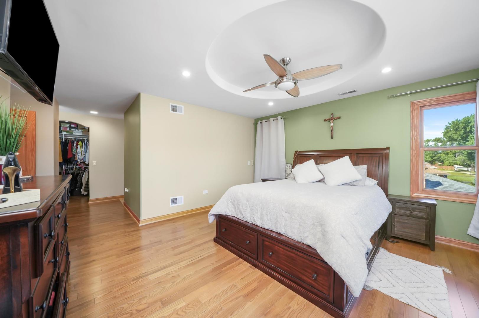 5907 West 109th Street Chicago Ridge, IL 60415 - Photo 20 of 45 a bedroom with a bed and a chandelier