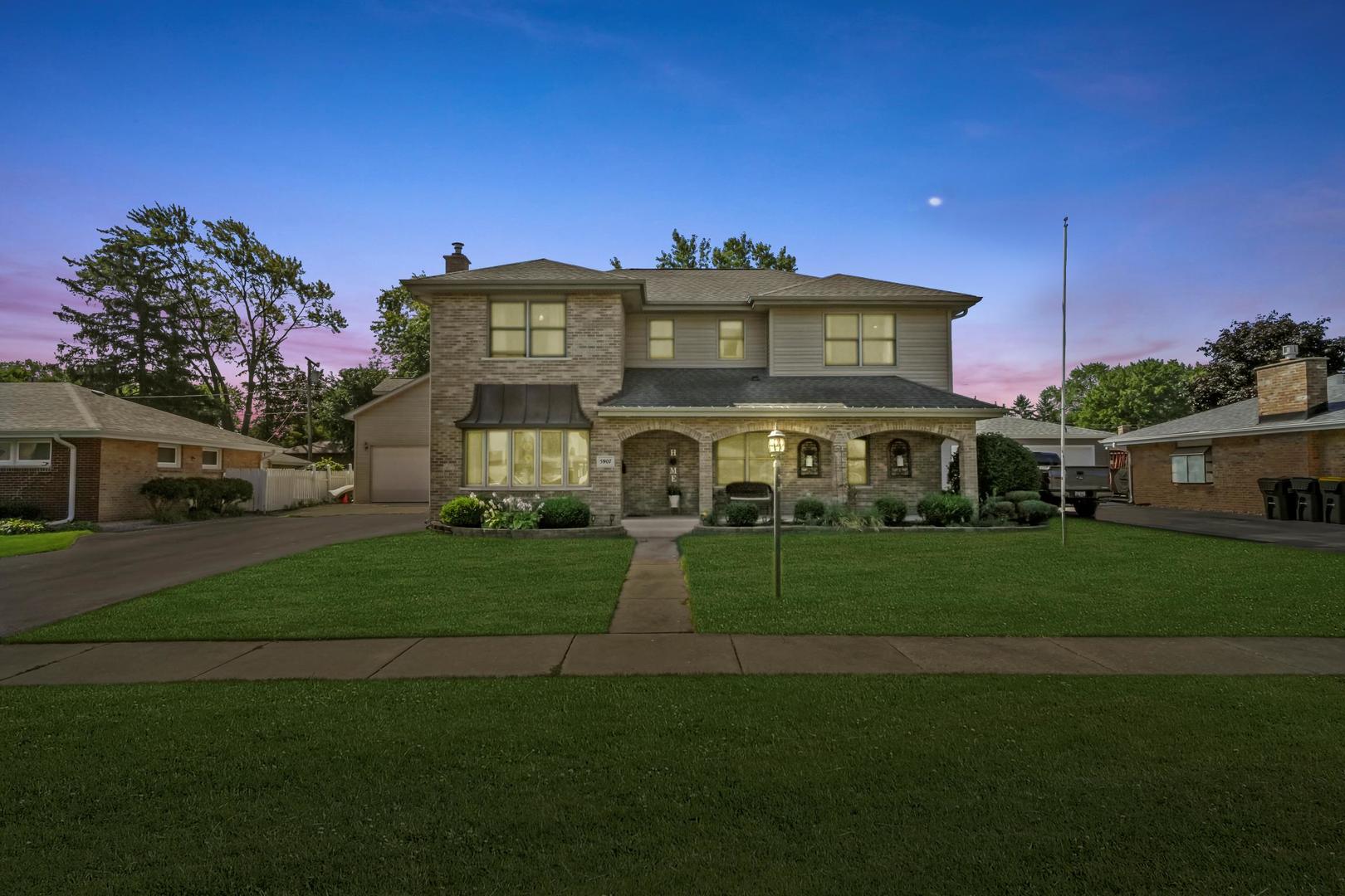 5907 West 109th Street Chicago Ridge, IL 60415 - Photo 2 of 45 a front view of a house with a garden
