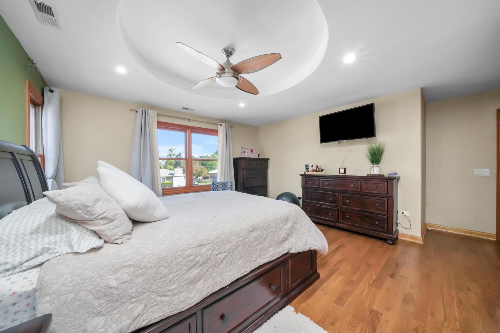 5907 West 109th Street Chicago Ridge, IL 60415 - Photo 21 of 45 a bedroom with a large bed and a flat screen tv