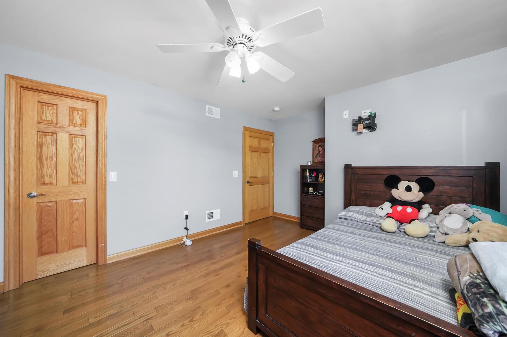 5907 West 109th Street Chicago Ridge, IL 60415 - Photo 29 of 45 a bedroom with a bed and wooden floor