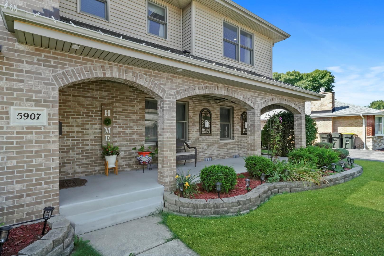 5907 West 109th Street Chicago Ridge, IL 60415 - Photo 3 of 45 a front view of a house with a garden