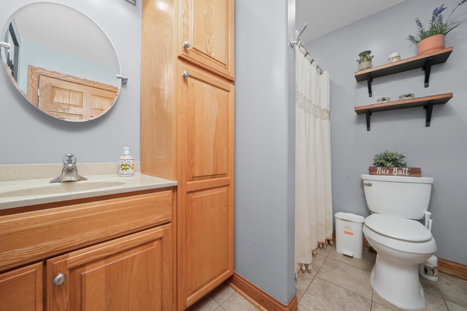 5907 West 109th Street Chicago Ridge, IL 60415 - Photo 33 of 45 a bathroom with a toilet a sink and a mirror