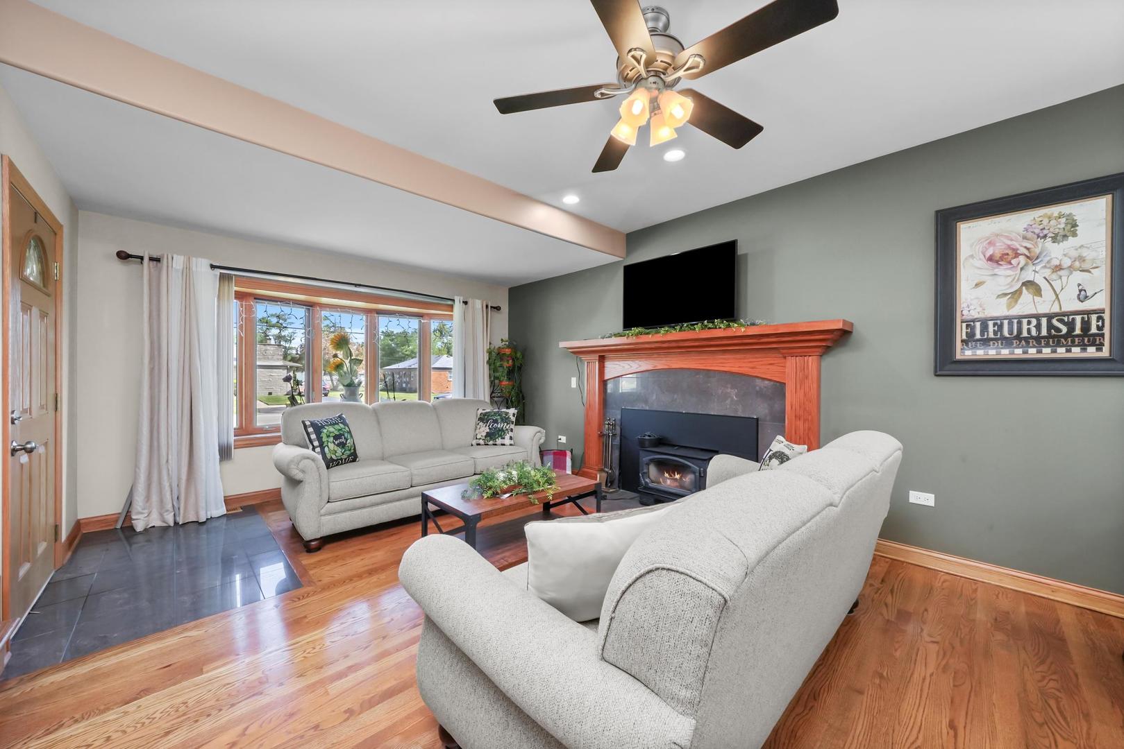 5907 West 109th Street Chicago Ridge, IL 60415 - Photo 41 of 45 a living room with furniture a fireplace and a flat screen tv