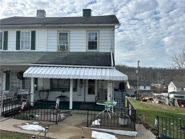 a front view of a house with sitting area