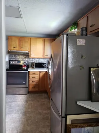 a kitchen with stainless steel appliances a refrigerator and a stove