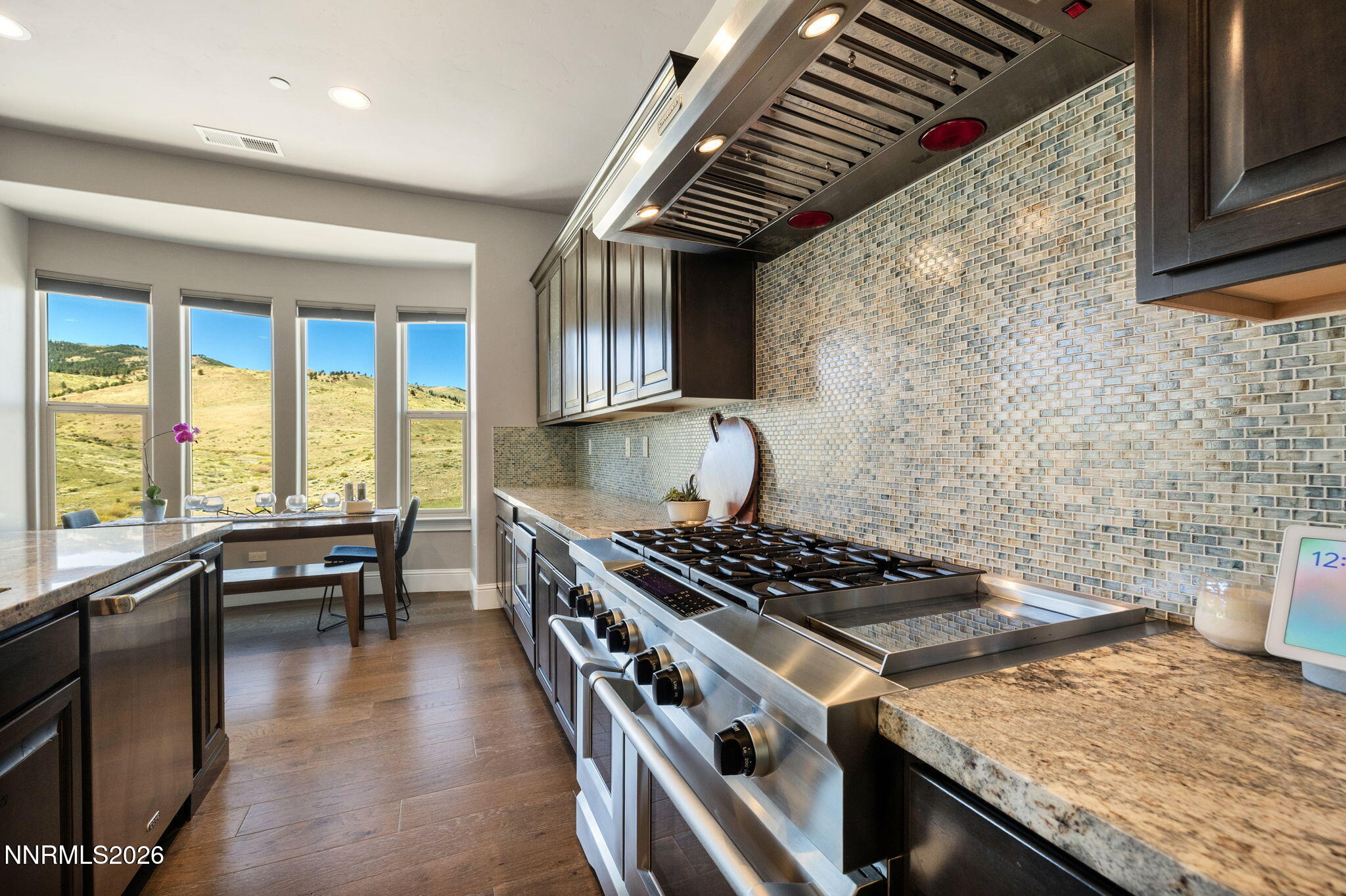 3172 Vista Favoloso Reno, NV 89519 - Photo 11 of 71 a kitchen with a stove a sink a dining table and chairs