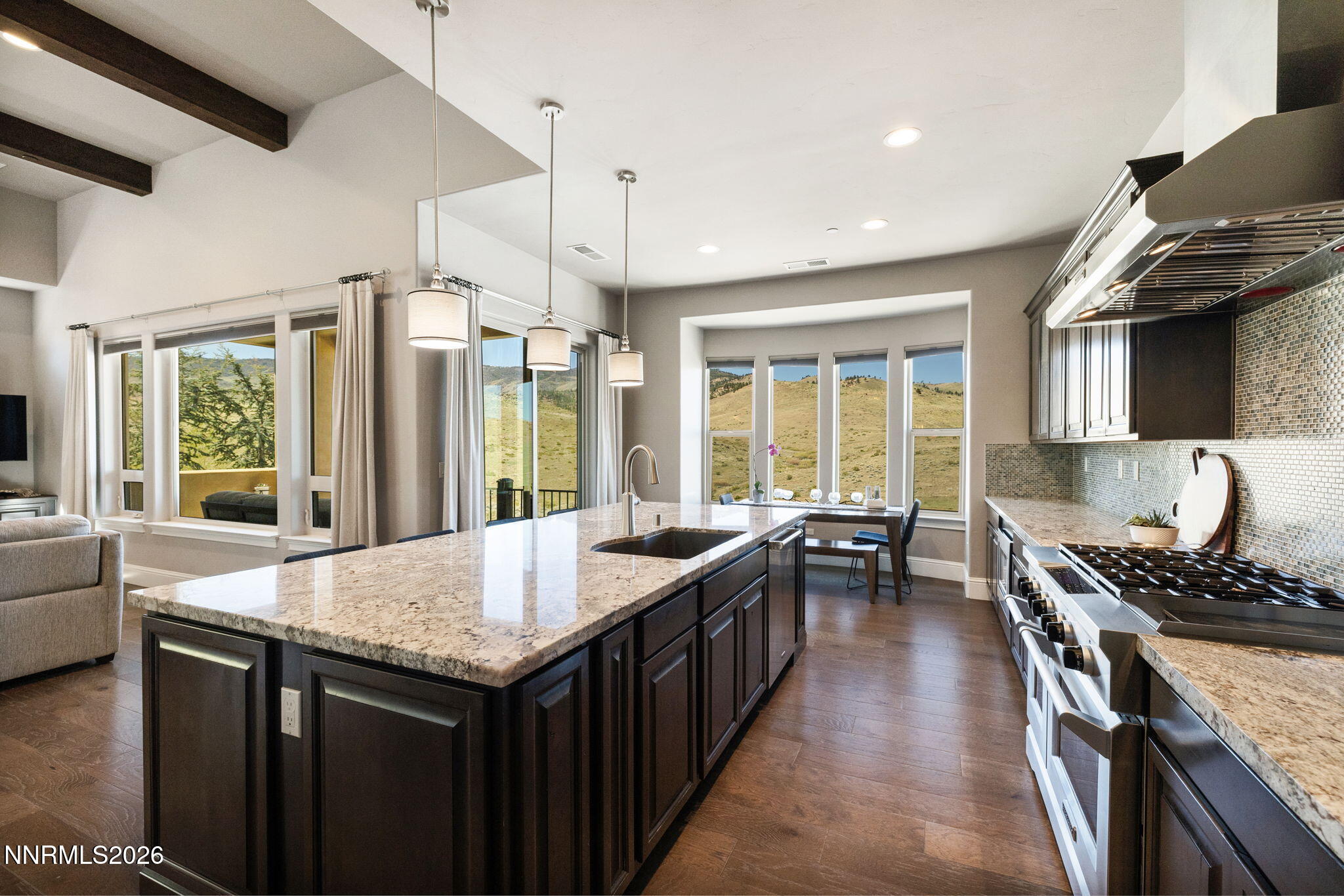 3172 Vista Favoloso Reno, NV 89519 - Photo 13 of 71 a kitchen with granite countertop a stove a sink a refrigerator and wooden cabinets