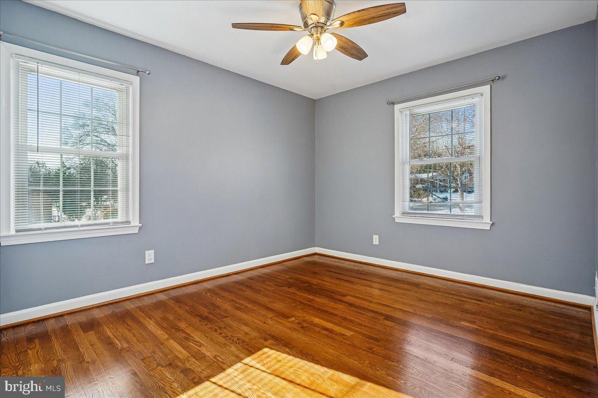 7039 Calamo Street Springfield, VA 22150 - Photo 27 of 70 a view of an empty room with wooden floor and a window