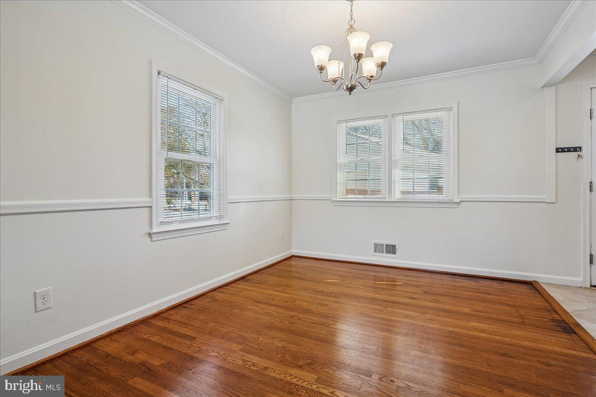 7039 Calamo Street Springfield, VA 22150 - Photo 8 of 70 a view of empty room with wooden floor and fan