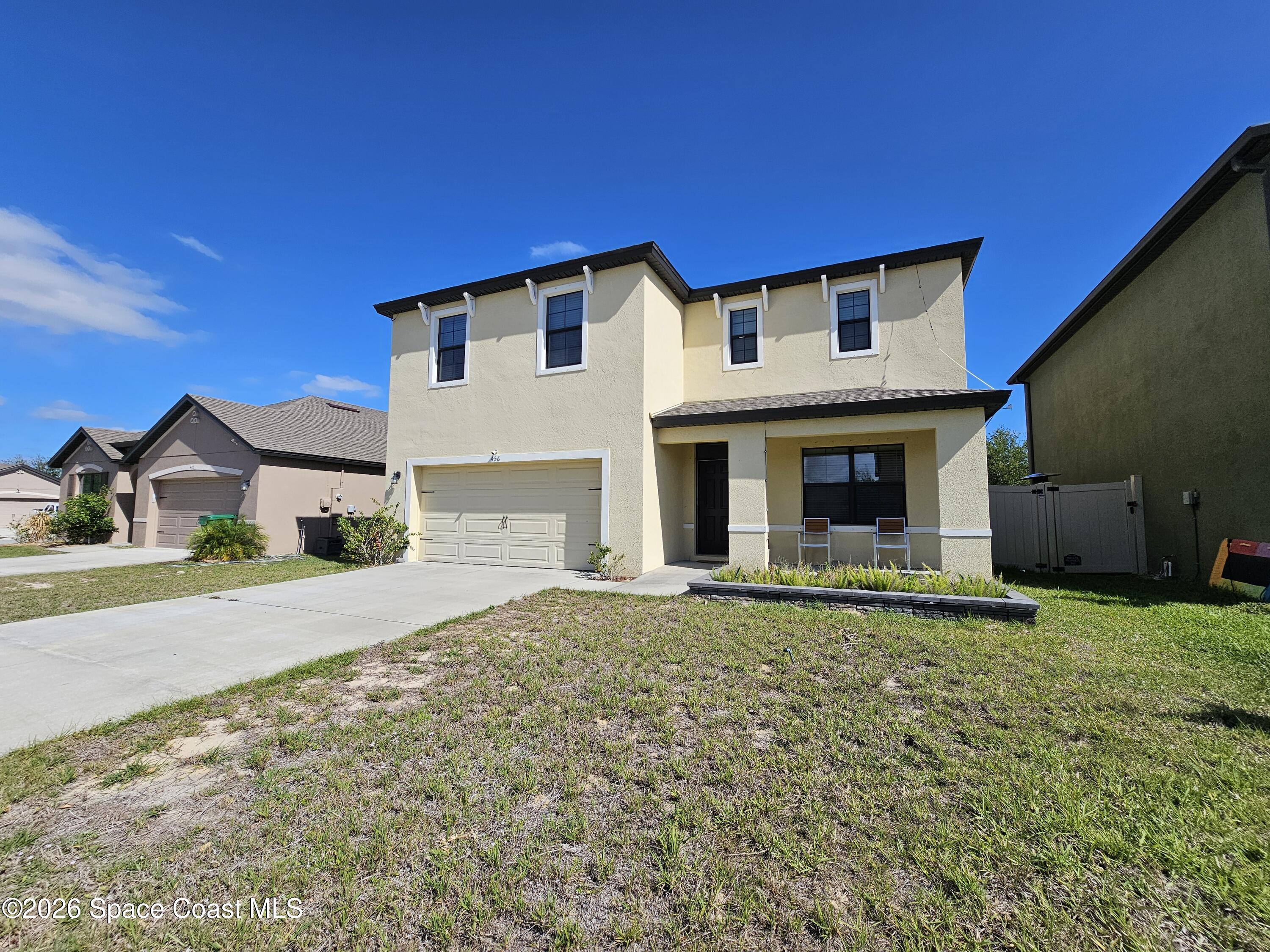 456 Snook Place Cocoa, FL 32927 - Photo 1 of 15 a front view of a house with a yard