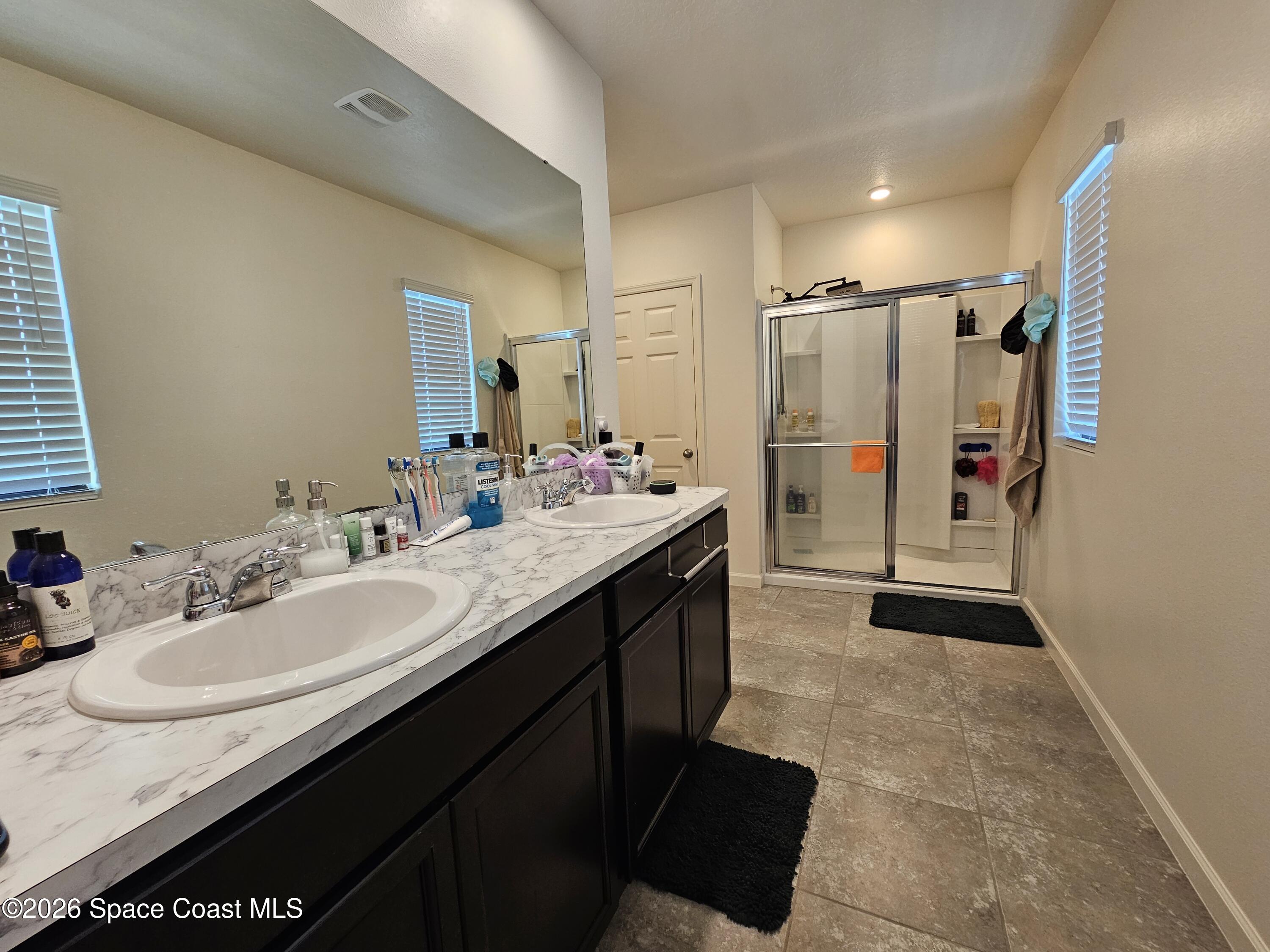 456 Snook Place Cocoa, FL 32927 - Photo 11 of 15 a bathroom with a sink double vanity granite tub shower and a mirror