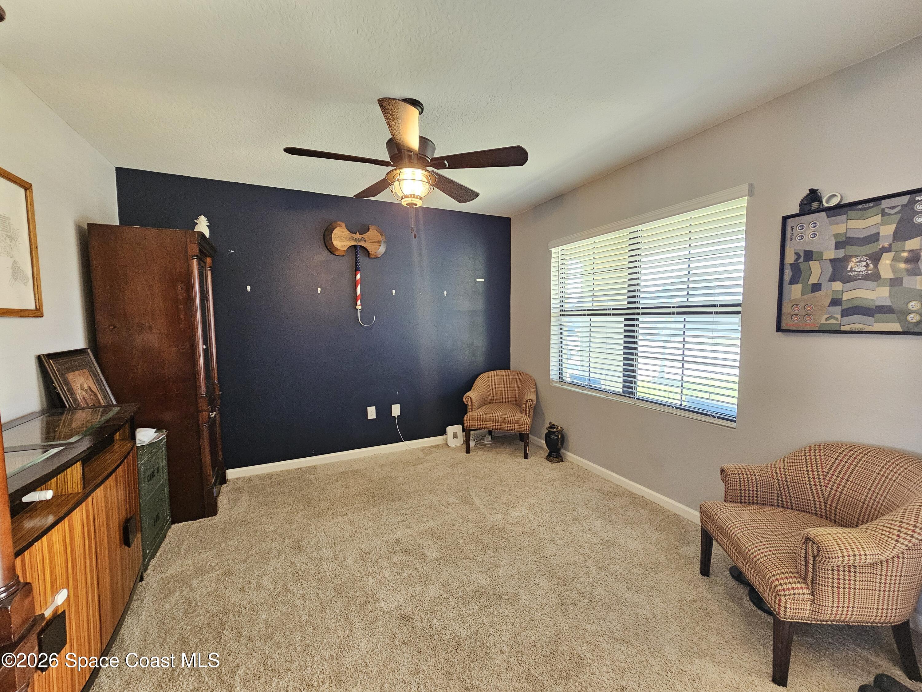 456 Snook Place Cocoa, FL 32927 - Photo 3 of 15 a bedroom with a bed and furniture