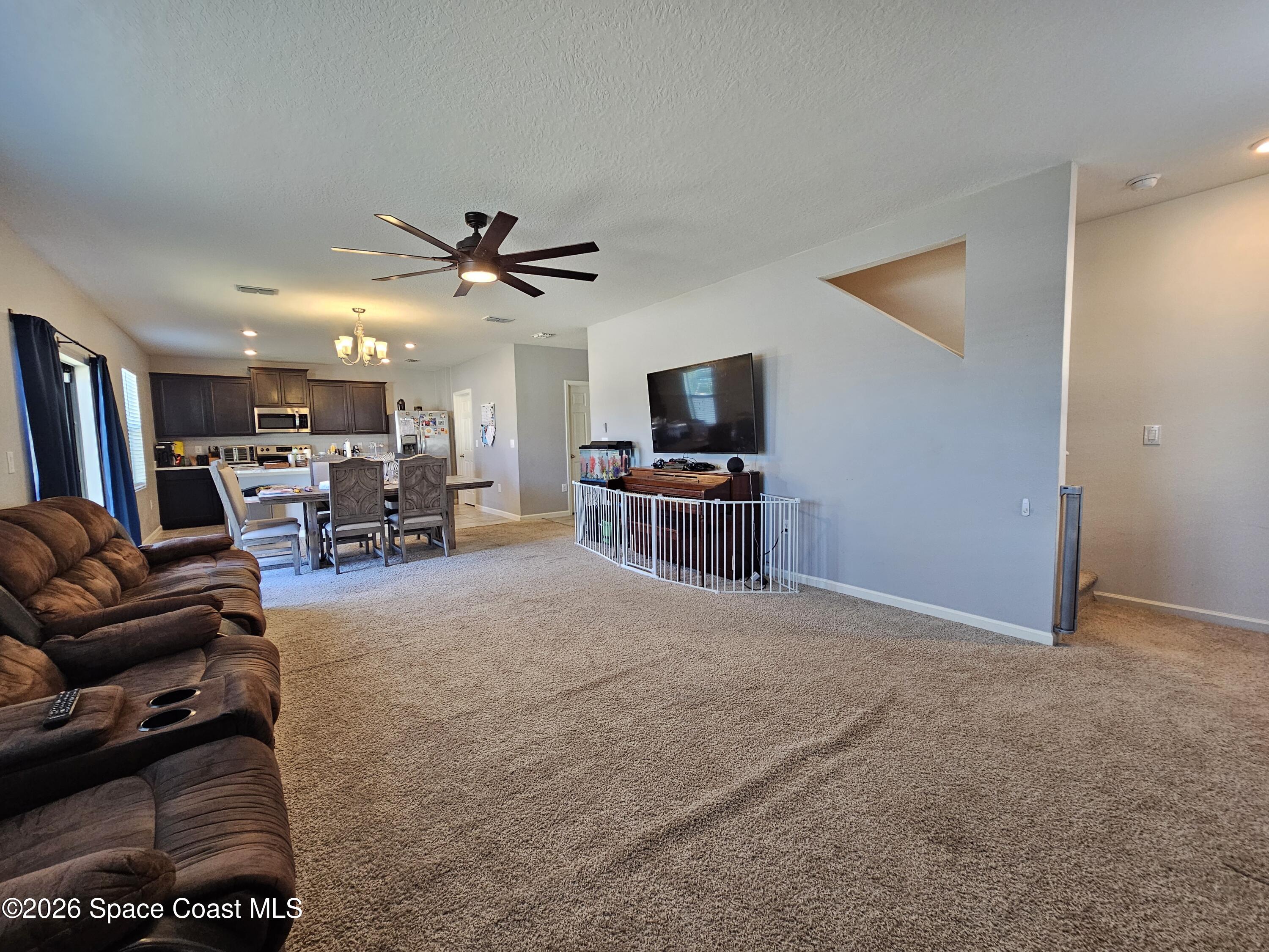 456 Snook Place Cocoa, FL 32927 - Photo 9 of 15 a living room with furniture and a flat screen tv