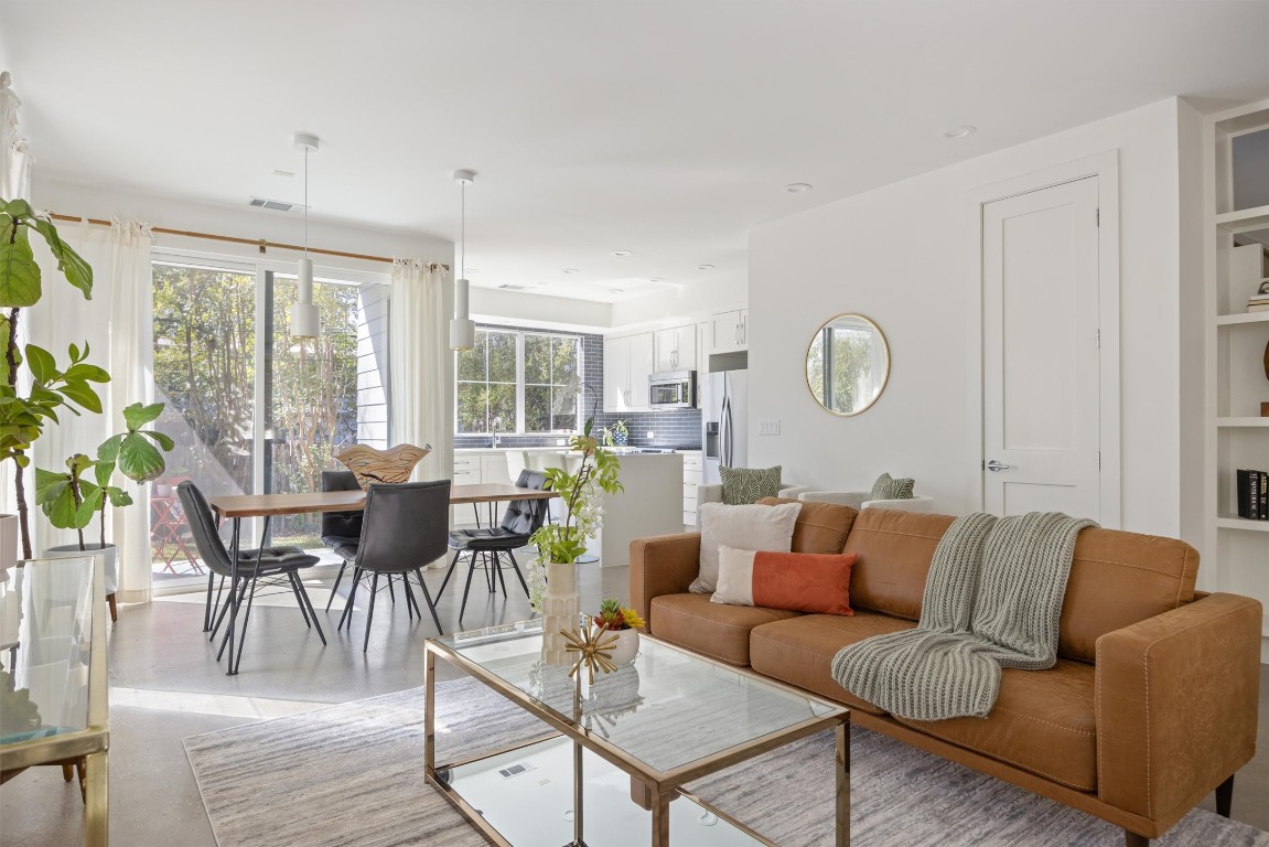 Living room featuring built in shelves and recessed lighting