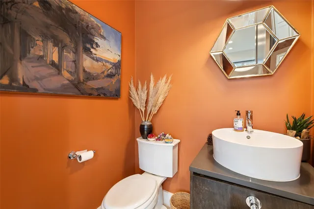 a bathroom with a toilet a sink and mirror