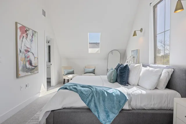 a bedroom with a bed and a painting on the wall