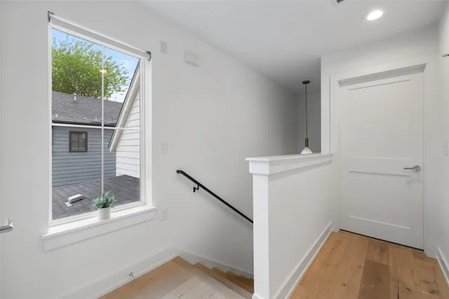 a view of small space with wooden floor and white walls