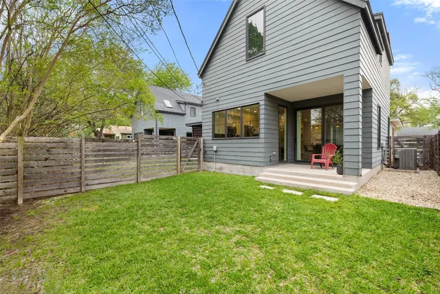 a view of a house with a yard and sitting area