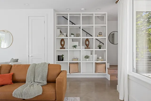 a living room with furniture a rug and a window