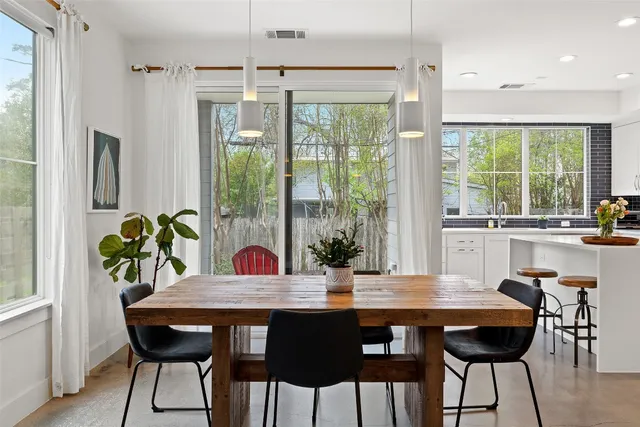 a view of a dining room with furniture window and outside view