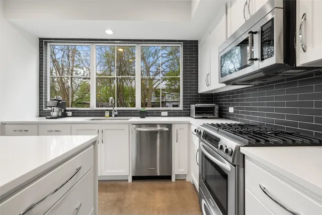 a kitchen with a stove a sink and a refrigerator