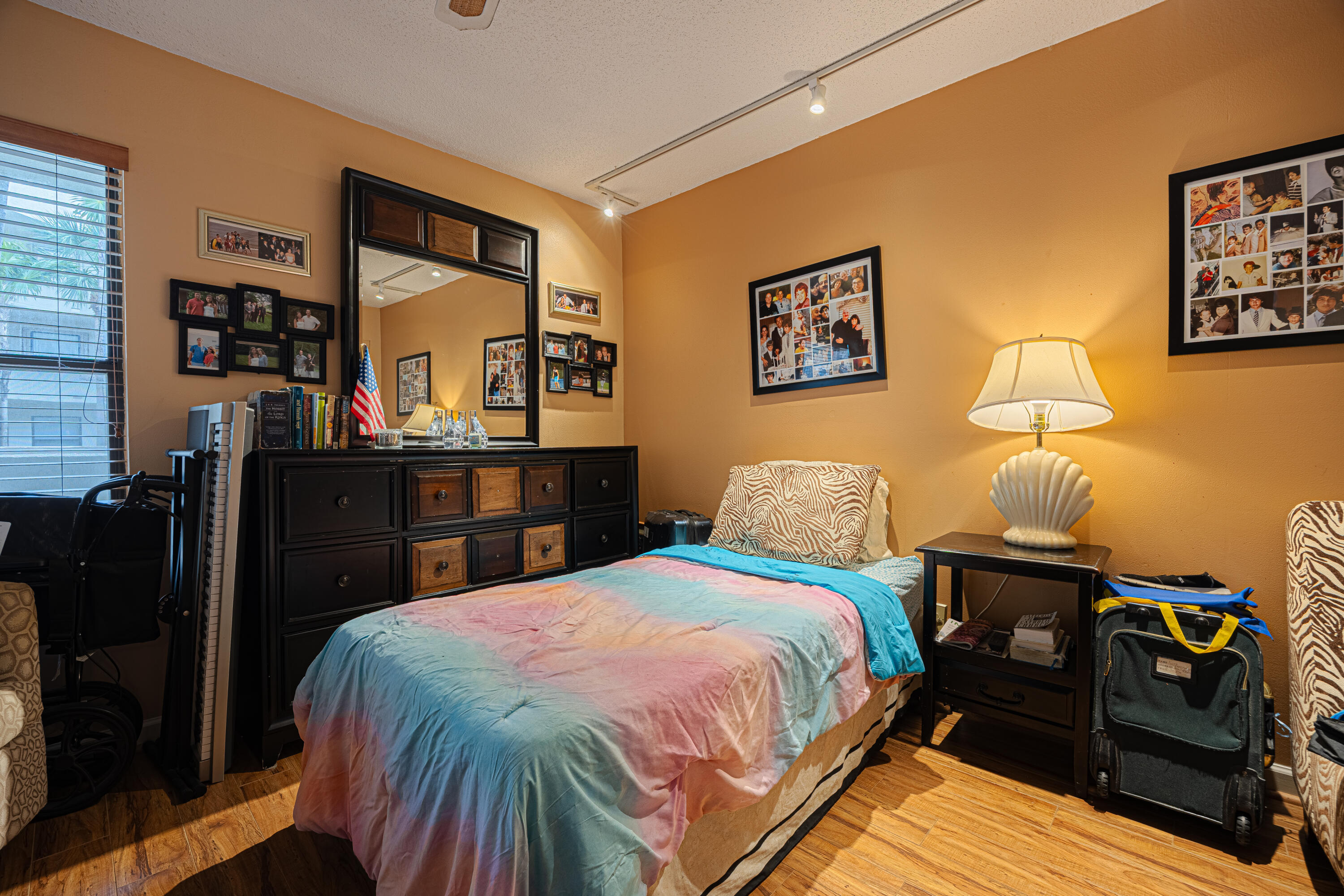 5750 Camino Del Sol, Unit 202 Boca Raton, FL 33433 - Photo 14 of 24 a bedroom with a bed and wooden floor