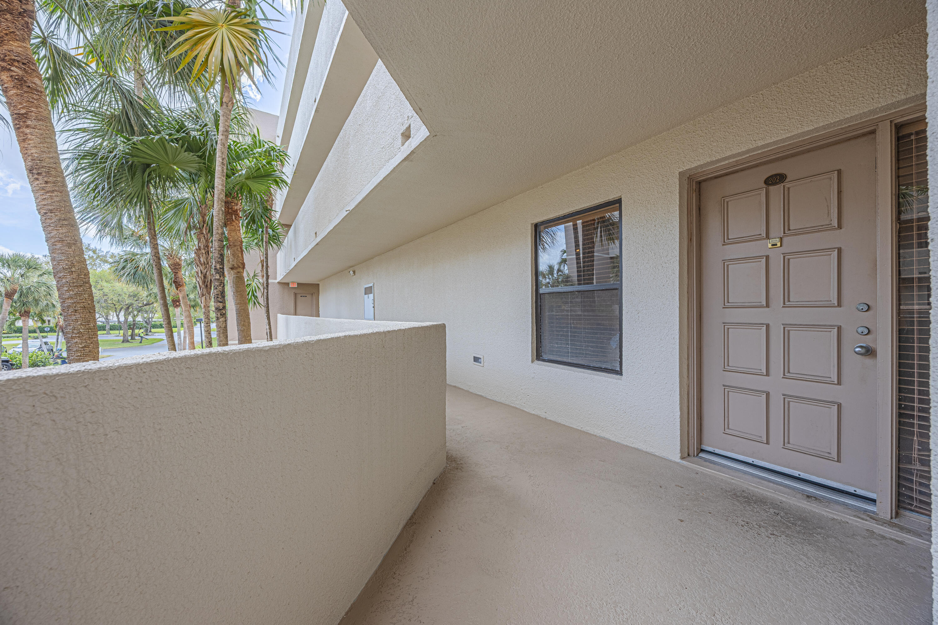 5750 Camino Del Sol, Unit 202 Boca Raton, FL 33433 - Photo 2 of 24 a view of an empty room with windows