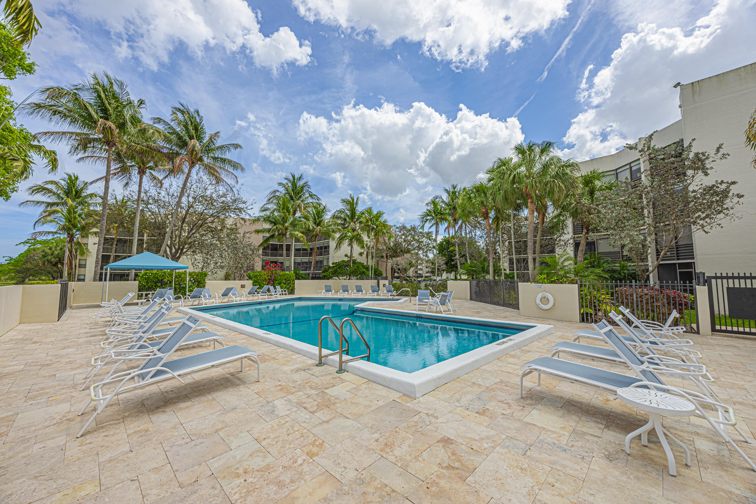 5750 Camino Del Sol, Unit 202 Boca Raton, FL 33433 - Photo 22 of 24 a view of a swimming pool with a patio