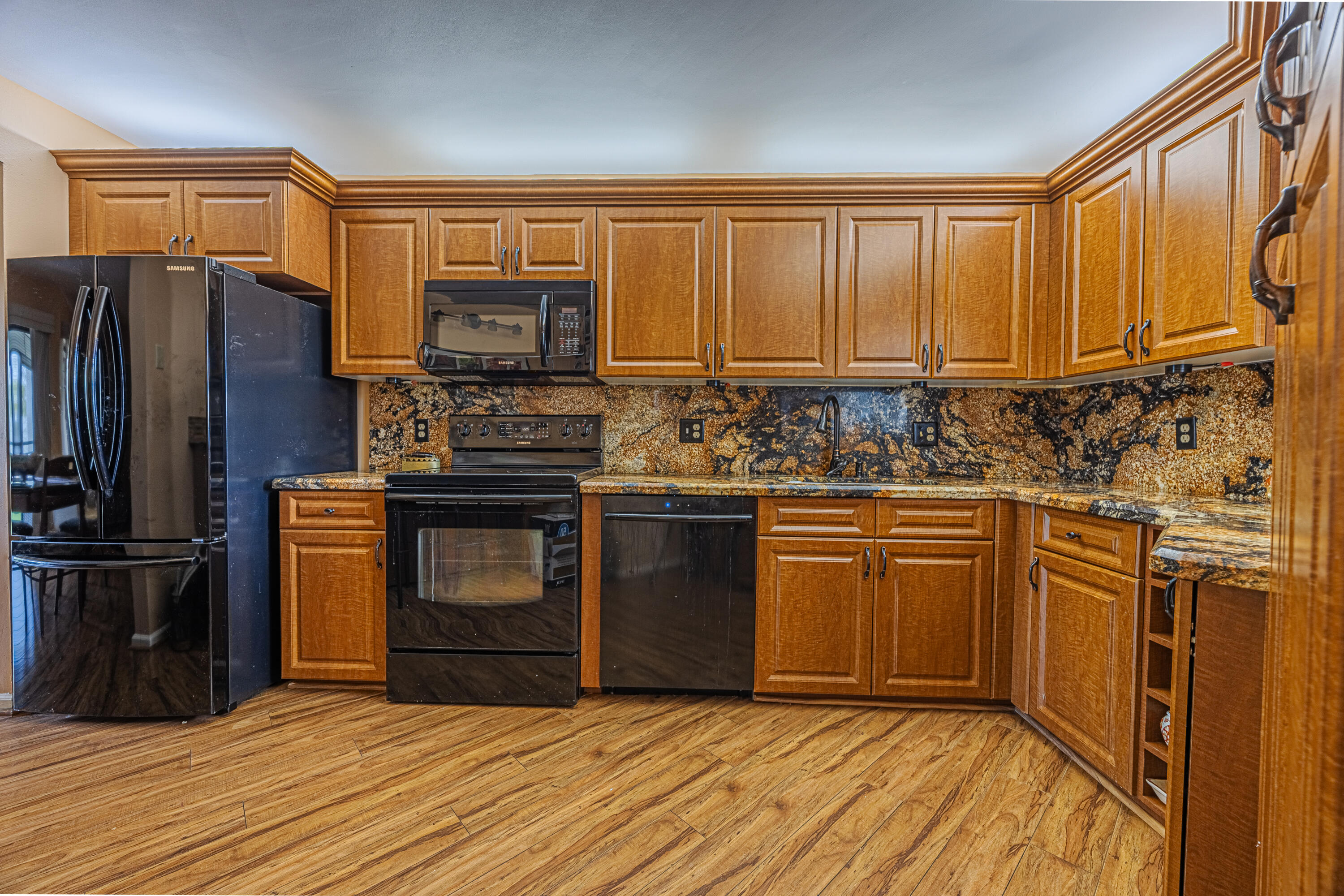 5750 Camino Del Sol, Unit 202 Boca Raton, FL 33433 - Photo 6 of 24 a kitchen with stainless steel appliances granite countertop a refrigerator stove top oven and sink