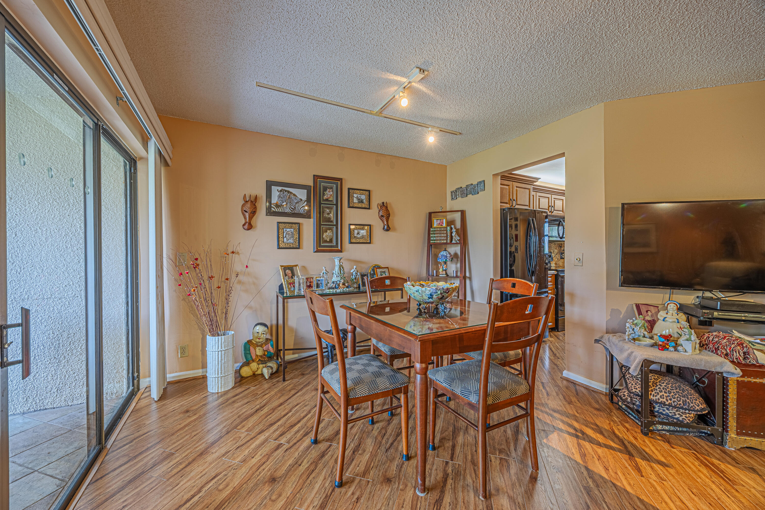 5750 Camino Del Sol, Unit 202 Boca Raton, FL 33433 - Photo 8 of 24 a view of a dining room with furniture and wooden floor