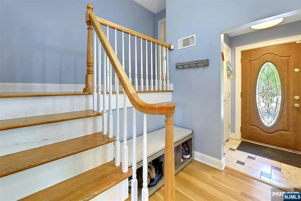 514 Rutland Avenue Teaneck, NJ 07666 - Photo 5 of 40 a view of a hallway with entryway wooden floor and front door