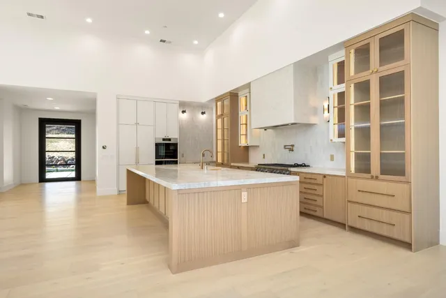 a view of a field with trees in the background