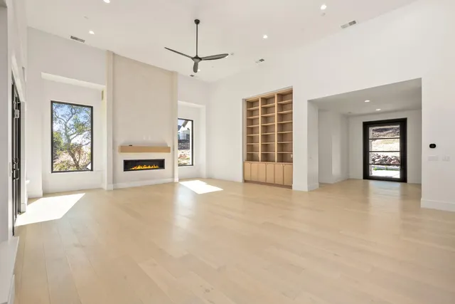 a yard with lots of green space and trees in the background