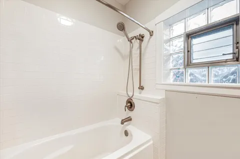 a bath tub sitting next to a window