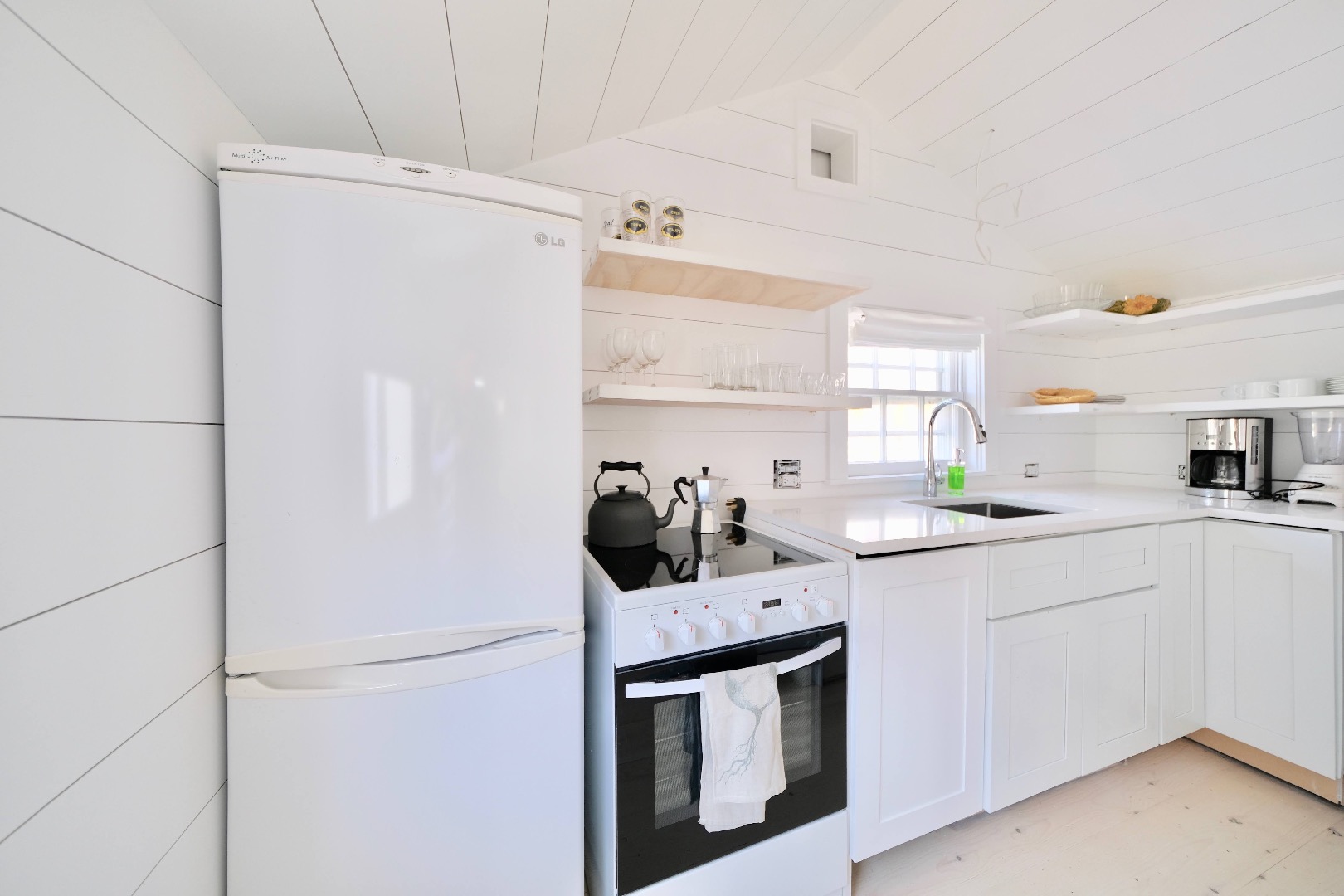 4 Cabot Lane Nantucket, MA 02554 - Photo 7 of 16 a kitchen with a sink and white cabinets