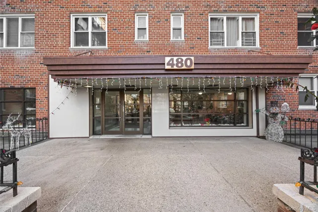 a view of building with refrigerator and outdoor seating