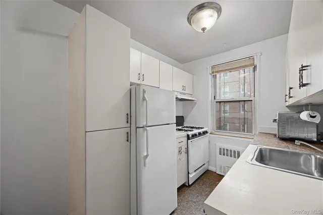 a kitchen with a sink cabinets and window