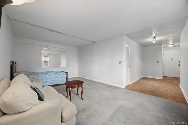 a bedroom with a bed a couch and dresser