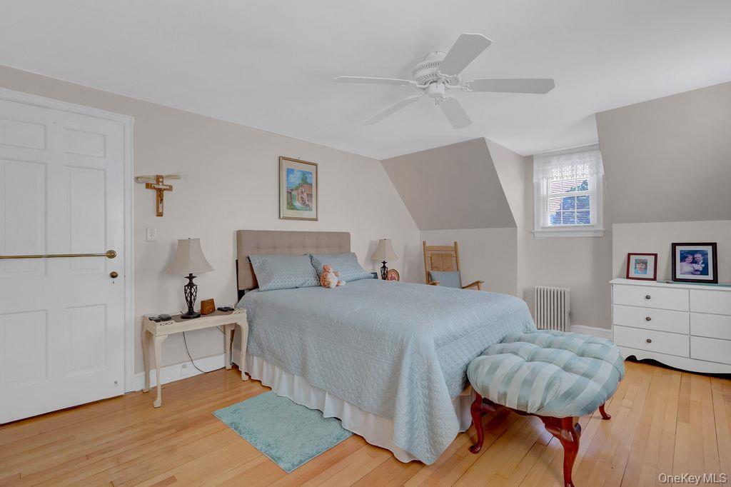 5 Newell Road Merrick, NY 11566 - Photo 12 of 19 a bedroom with a large bed and a chandelier