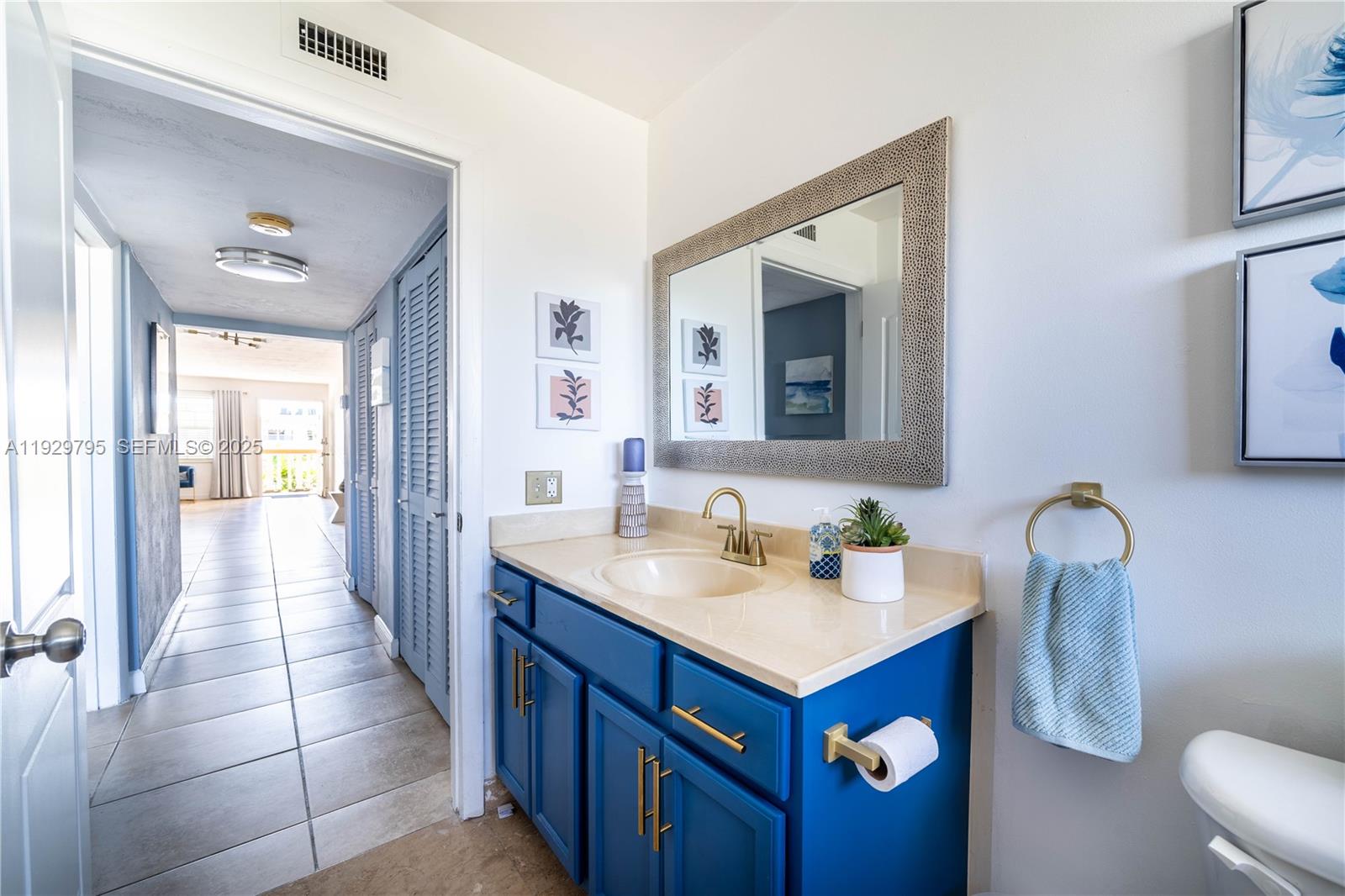 1855 Northeast 121st Street, Unit 32 North Miami, FL 33181 - Photo 13 of 22 a bathroom with a sink vanity and mirror