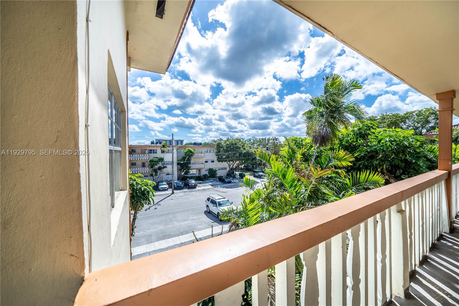 1855 Northeast 121st Street, Unit 32 North Miami, FL 33181 - Photo 20 of 22 a view of a balcony with potted plants