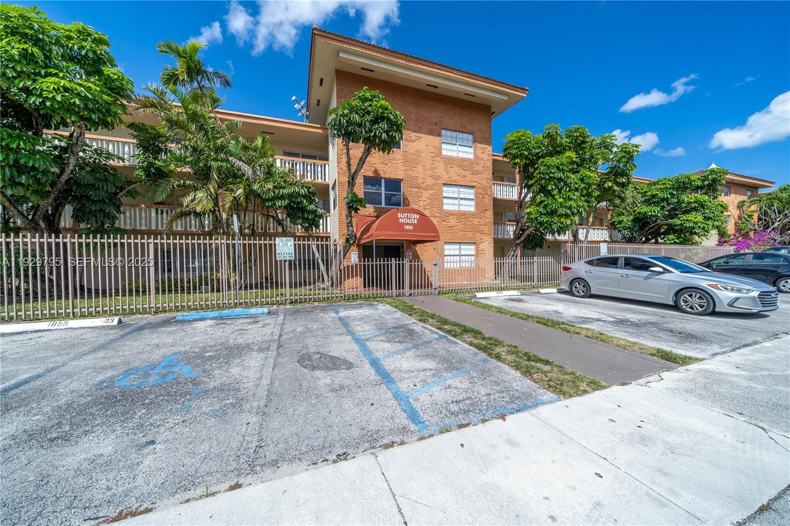 1855 Northeast 121st Street, Unit 32 North Miami, FL 33181 - Photo 21 of 22 a view of a house with a small yard and potted plants