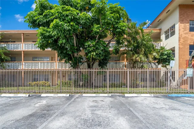 a view of a yard with a fence and a trees
